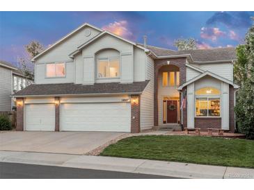 Charming two-story home with a well-manicured lawn, three car garage and attractive brick accents at 16667 Tin Cup Ct, Parker, CO 80134