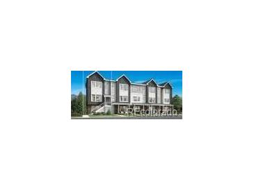 Modern townhome featuring dark gray siding, a covered porch, and an elevated front entry at 700 Saddle Dr, Erie, CO 80516