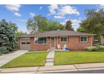 Charming red brick single-story home with a well-manicured lawn and an attached one car garage at 3384 W Arlington Ave, Littleton, CO 80123