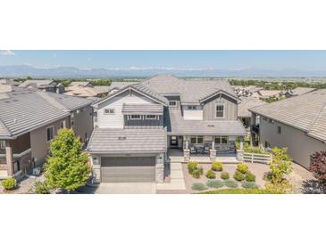 Two-story home with meticulous landscaping and a covered porch, offering great curb appeal and mountain views at 16383 Ute Peak Way, Broomfield, CO 80023