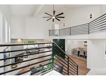Bright open concept living and dining area with vaulted ceilings and modern staircase at 7309 Windsor Dr, Boulder, CO 80301
