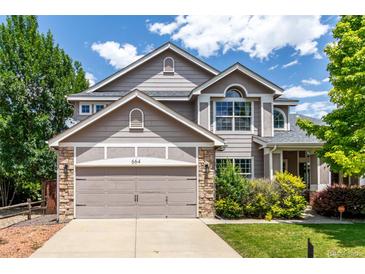 Charming two-story home featuring a two-car garage and well-maintained landscaping under a sunny sky at 664 Clarendon Dr, Longmont, CO 80504