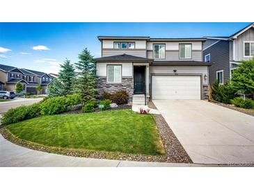 Charming two-story home featuring a well-manicured front yard and attached two car garage at 350 Vista Cliff Cir, Castle Rock, CO 80104