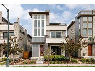 Striking contemporary home featuring a two-story facade and professionally landscaped front yard at 6068 Beeler Ct, Denver, CO 80238