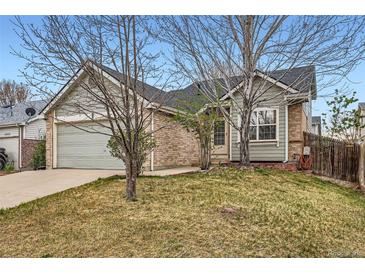 Charming home with a two-car garage, brick accents, and mature trees in a well-maintained front yard at 4933 Altura St, Denver, CO 80239
