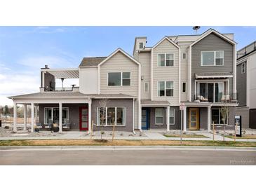 Modern three-story townhome with private balcony and landscaped front yard at 888 S Valentia St # 103, Denver, CO 80247