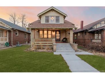 Charming craftsman home with a welcoming front porch and well-manicured lawn at 4415 N Clay St, Denver, CO 80211