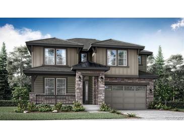 Two story home with a neutral color palette, stone accents, a covered porch and a two car garage at 7426 S Yank Ct, Littleton, CO 80127