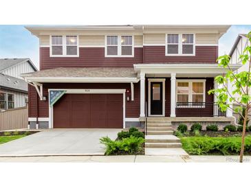 Two-story home with a front-entry garage, covered porch, and nicely landscaped front yard at 1826 Hickory Ave, Erie, CO 80516