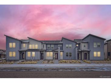 Beautiful row of modern townhomes features coordinated paint scheme and minimalist rock landscaping at 6492 N Ceylon St, Denver, CO 80249