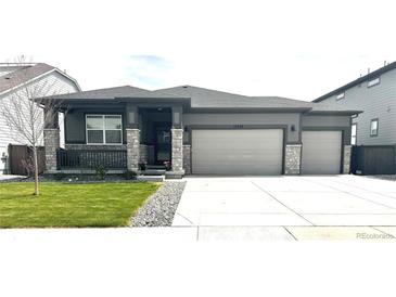 Charming home with stone accents, well-kept lawn, and a three-car garage for ample parking at 13432 Broad Wing Dr, Parker, CO 80134