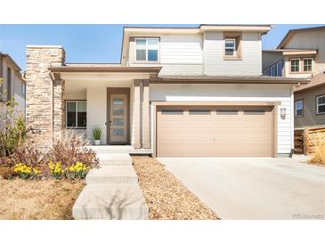 Charming two-story home with a stone accent and a large front-facing two car garage at 11041 Richfield Cir, Commerce City, CO 80022