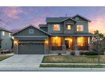 Charming two-story home with a stone facade, covered porch, and well-maintained lawn at 13673 Osage St, Broomfield, CO 80023