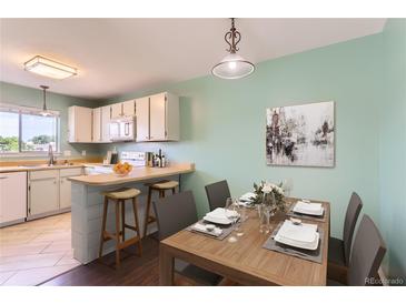 Cozy dining area has a breakfast bar, counter seating, and neutral-toned decor, creating a comfortable dining space at 8635 Clay St # 417, Westminster, CO 80031