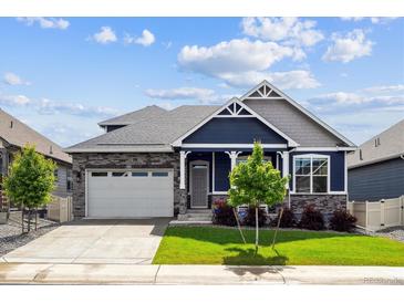 Charming blue two-story home with landscaped yard, stone accents, and a well manicured lawn at 8888 Falcon St, Longmont, CO 80504