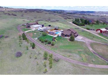 Expansive property featuring a large home, pool, outbuildings, and plenty of land at 1063 Clarke Ct, Castle Rock, CO 80109