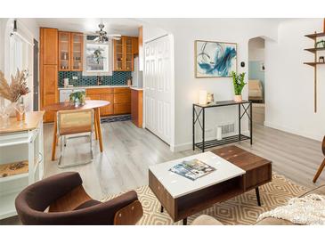 Bright, updated kitchen and dining area with wood cabinets and stylish decor at 1171 Quebec St, Denver, CO 80220