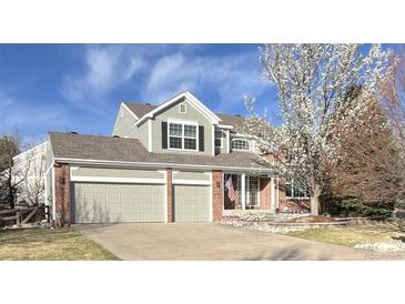 Charming two-story home with a three-car garage and well-maintained lawn and landscape at 18168 E Caley Cir, Aurora, CO 80016