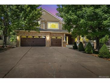 Beautiful brick home with a three-car garage and mature landscaping at 3901 Stonegrass Pt, Broomfield, CO 80023