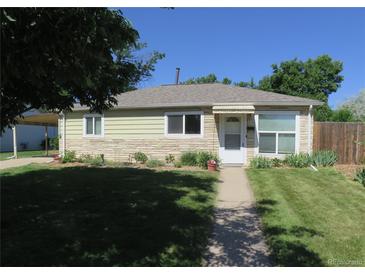 Charming single-story home with a well-manicured lawn and inviting walkway at 1271 Xapary St, Aurora, CO 80011