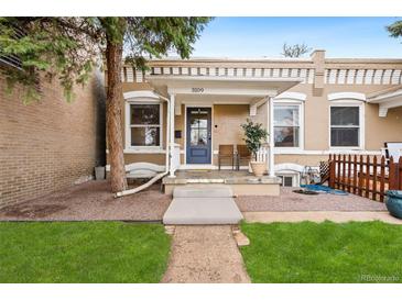 Charming home featuring a welcoming front porch, freshly cut grass, and meticulous landscaping at 3109 N Williams St, Denver, CO 80205