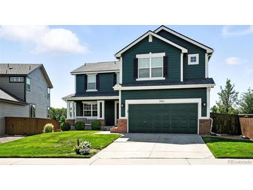 Two-story home with a two-car garage, lush lawn, and well-maintained landscaping at 3543 Foxridge Trl, Highlands Ranch, CO 80126
