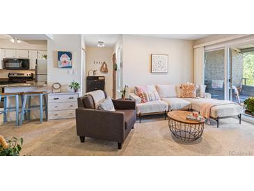 Inviting living room featuring a comfortable sectional sofa and decor with access to an outdoor patio at 5300 E Cherry Creek South Dr # 124, Denver, CO 80246