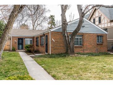 Charming brick home featuring a well-maintained lawn and mature trees at 482 N Humboldt St, Denver, CO 80218