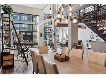 Open dining area with tall ceilings, stylish lighting, and unique bike rack at 3100 Huron St # 4Q, Denver, CO 80202