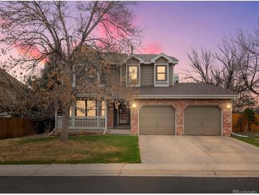 Charming two-story home featuring a welcoming front porch and a two car garage at 1123 E 132Nd Way, Thornton, CO 80241