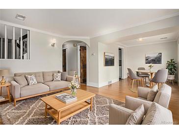 Bright living room featuring hardwood floors, neutral colors, and stylish furnishings at 14753 E Alabama Pl, Aurora, CO 80012