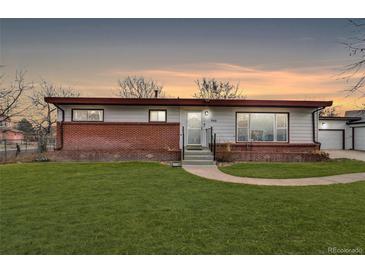 Charming single-story home with well-manicured lawn and brick accents at 940 S Geneva St, Aurora, CO 80247