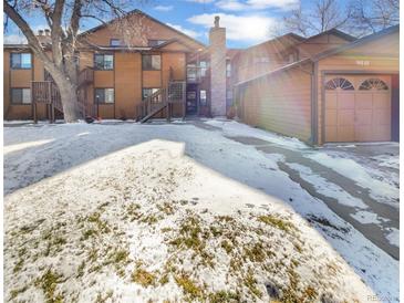 Attractive exterior of a two-story townhome with snow-covered landscaping and attached garage at 9010 W 88Th Cir, Westminster, CO 80021