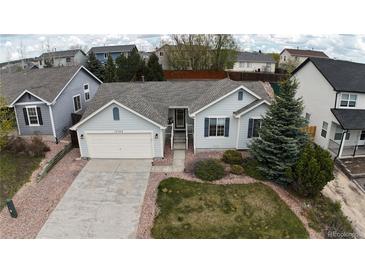 Charming single-story home features a well-maintained lawn, mature trees and an attached two-car garage at 17145 Park Trail Dr, Monument, CO 80132