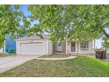 Charming single Gathering home with a two car garage, brick accents and inviting front porch at 10441 Routt Ln, Broomfield, CO 80021