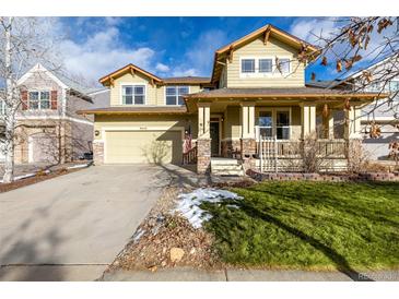 Two-story house with a front porch and landscaped yard at 8445 Braun Loop, Arvada, CO 80005