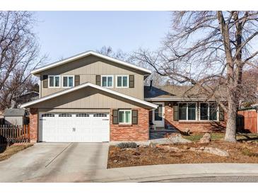 Inviting two-story home with attached garage, brick accents, and well-maintained front yard at 6705 Youngfield Ct, Arvada, CO 80004