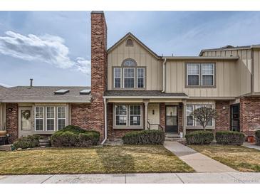 Charming two-story townhouse with a brick chimney, well-kept lawn and inviting entrance at 9618 W Chatfield Ave # B, Littleton, CO 80128