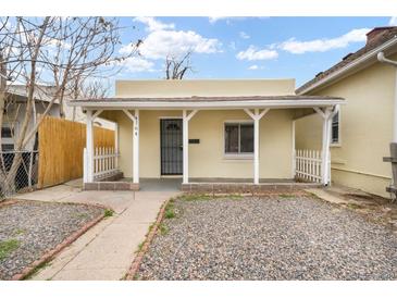 Charming home with a covered porch, metal door, and gravel landscaping at 4764 High St, Denver, CO 80216