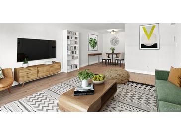 Cozy living room adjacent to dining area, showcasing modern decor, comfortable seating, and a stylish rug at 7755 E Quincy Ave # 203A2, Denver, CO 80237