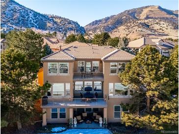 Stunning two-story home with balconies overlooking a scenic mountain backdrop in a beautiful upscale neighborhood at 16611 Red Cliff Cir, Morrison, CO 80465