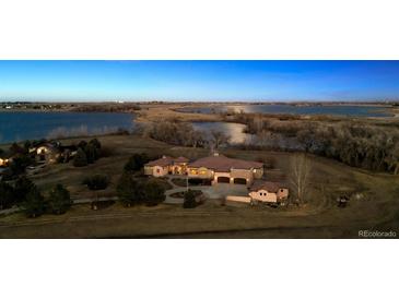 Stunning aerial view of the property with a lake and mature trees on a sprawling lot at 2102 Shoreside Dr, Berthoud, CO 80513