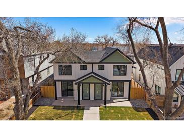 Charming two-story duplex with white siding, black trim, green accents, and a well-manicured front lawn at 2432 Ames St, Edgewater, CO 80214