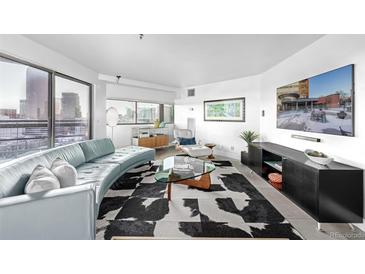 Bright living room with city views, modern furnishings, and a unique black-and-white patterned rug at 100 Park W Ave # 1606, Denver, CO 80205