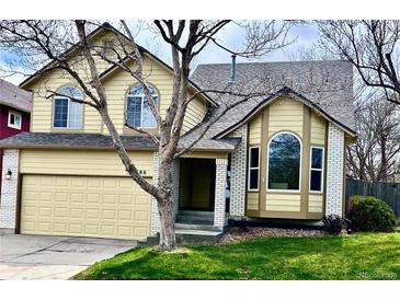 Charming two-story home with a well-maintained lawn and attached two-car garage at 9686 W 106Th Ave, Broomfield, CO 80021