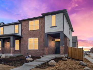 Charming two-story townhouse with brick and siding exterior and inviting front entrance at 775 N Tempe St, Aurora, CO 80018