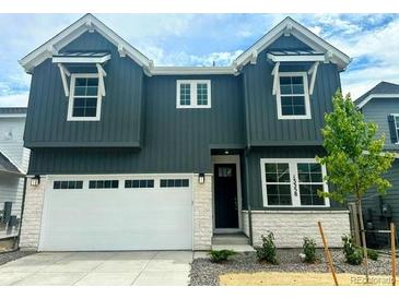 Two-story home featuring a modern exterior, two-car garage, and well-maintained landscaping at 13358 Blue Amber Ct, Parker, CO 80134
