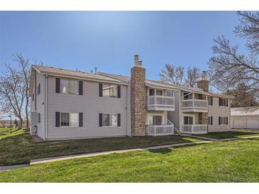 Charming two-story apartment building with well-maintained landscaping and inviting balcony at 14453 E Jewell Ave # 104, Aurora, CO 80012