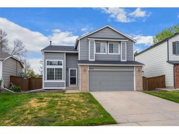 Charming gray two-story home with a well-maintained lawn and attached two-car garage at 9522 Castle Ridge Cir, Highlands Ranch, CO 80129