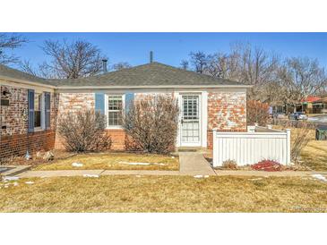 Charming brick home with a well-maintained front yard and blue shutters at 1209 Locust St, Denver, CO 80220